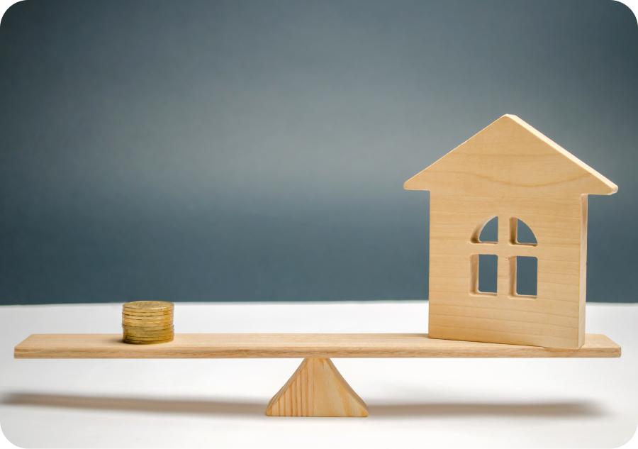 a scale with a house on one end and coins on the other representing fair housing