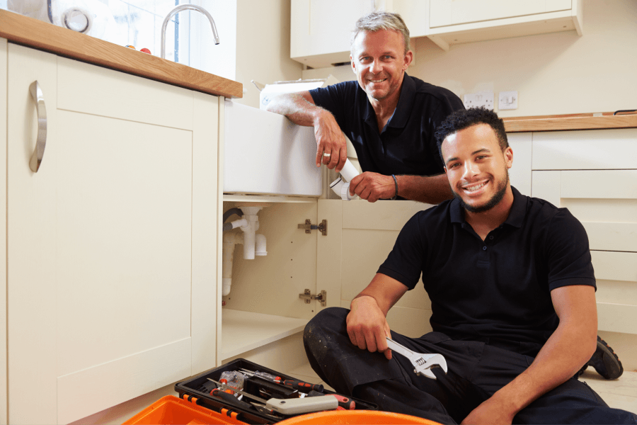 two smiling maintenance techs in the midst of training