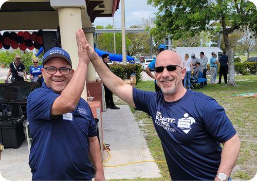 two maintenance technicians from atlantic pacific slapping five 