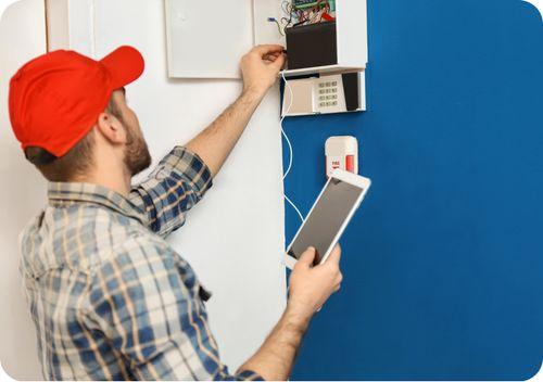 A man fixing an electric box using software, enabling efficiency.