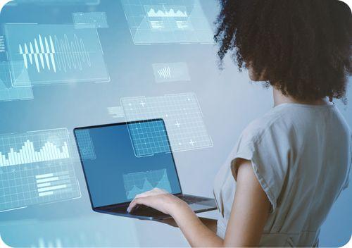 A woman holding a computer, referencing the power of data and how AppWork is revolutionizing multifamily maintenance.